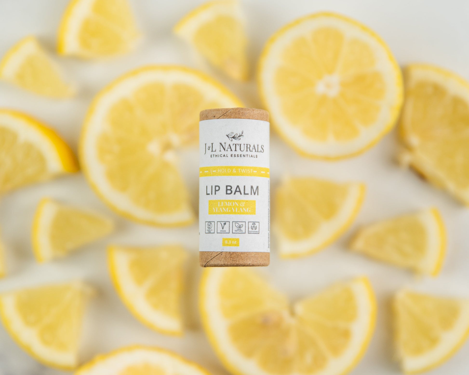 Lip Balm Lemon & Ylang Ylang with lemons in the background