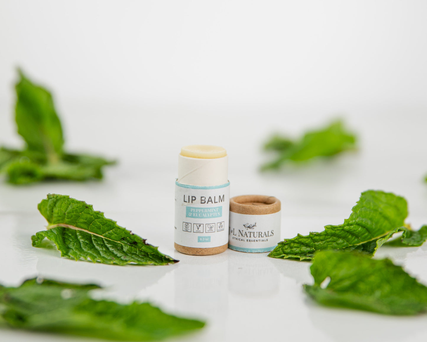 Lip Balm on display alongside fresh mint leaves