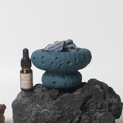 Blue Moon Diffuser displayed on a natural rock with essential oil