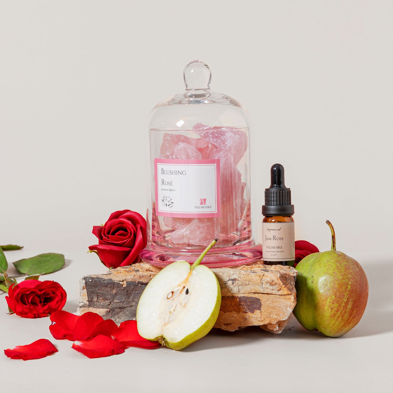 Blushing Rose Gemstone Diffuser surrounded by fresh roses and apples